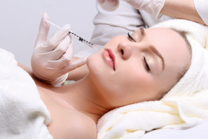 Anti aging facial mesotherapy with syringe closeup on woman face